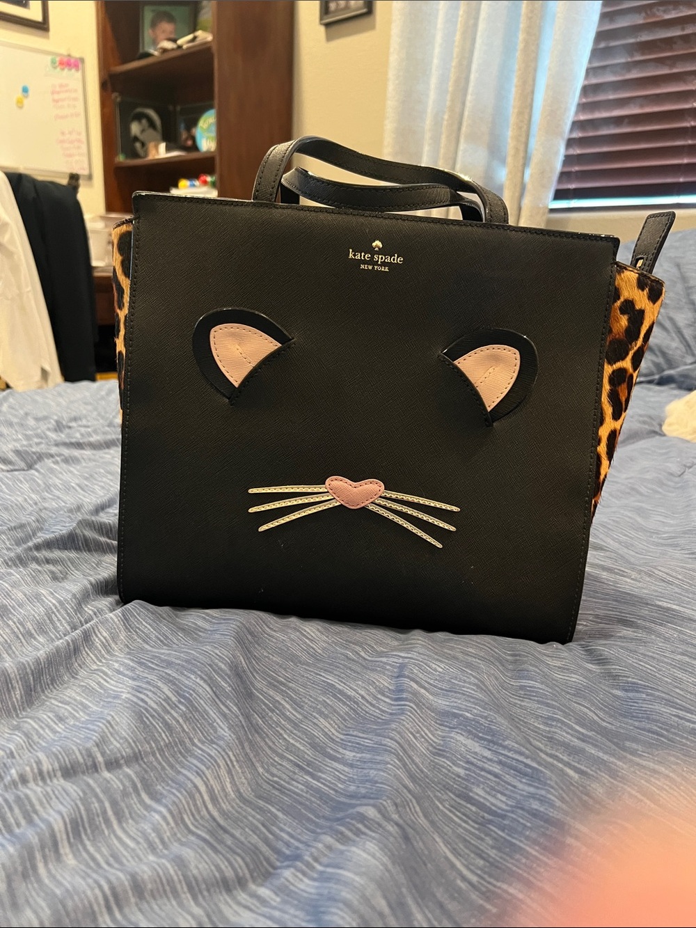 kate spade black satchel with pink cat appliqué and leopard sides